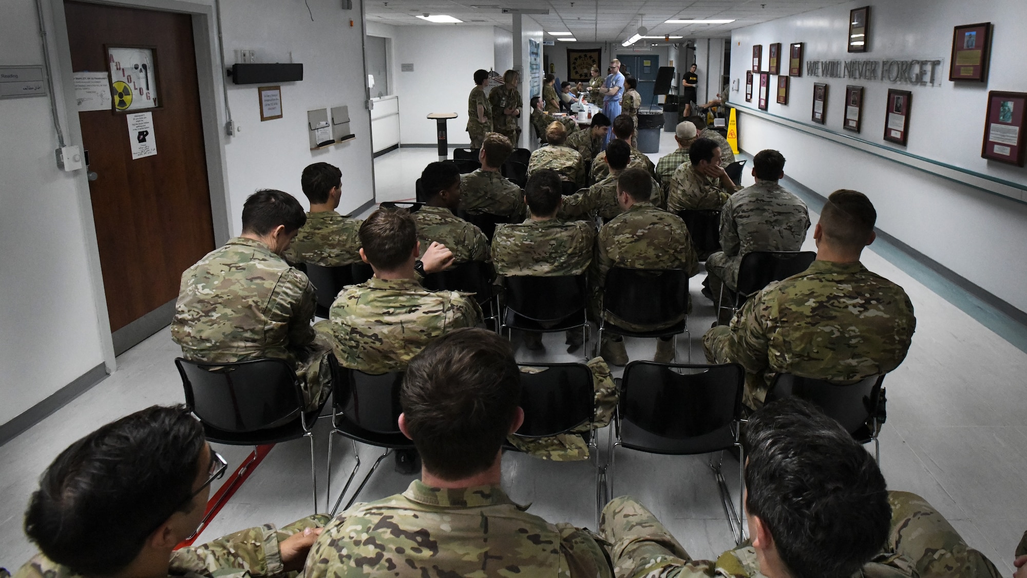 Service members wait in line to donate blood at Craig Joint Theater Hospital, Bagram Airfield, Afghanistan as part of a "walking blood bank" for a fellow service member being transferred to Brooke Army Medical Center, San Antonio, Texas, Aug. 18, 2019. A request for volunteers with a specific blood type was filled within minutes, providing fresh whole blood to sustain the patient during the 20-hour direct flight home. (U.S. Air Force photo by Airman 1st Class Ryan Mancuso)