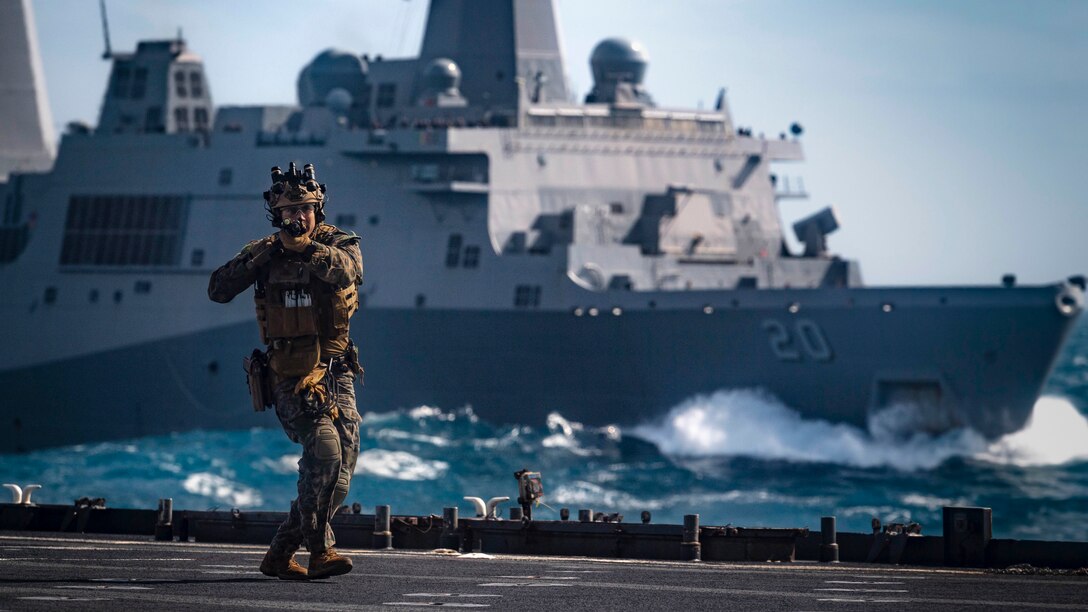 A Force Reconnaissance Marine with the 31st Marine Expeditionary Unit clears the flight deck of the amphibious dock landing ship USS Ashland during a visit, board, search and seizure training exercise with the amphibious transport dock ship USS Green Bay. Ashland, part of the Wasp Amphibious Ready Group, with embarked 31st Marine Expeditionary Unit, is operating in the Indo-Pacific region to enhance interoperability with partners and serve as a ready-response force for any type of contingency, while simultaneously providing a flexible and lethal crisis response force ready to perform a wide range of military operations.