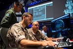 (From left) Brazilian Air Force Maj. Rafael de Almeida Duque, Brazilian Aerospace Command, collaborates with Spanish Air Force members at Lockheed Martin’s Center for Innovaton in Suffolk, Va., Sept. 27, 2019, during Global Sentinel 19. During the week, each participating nation maintained a space operations center (SpOC) to command and control their SSA space situational awareness.  (U.S. Air Force photo by Staff Sgt. J.T. Armstrong)