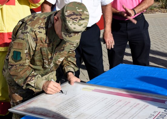 U.S. Air Force Col. Andres Nazario, 17th Training Wing commander, signs the proclamation declaring the second week of Oct. as Fire Prevention Week at the Norma Brown building on Goodfellow Air Force Base, Texas, Oct. 2, 2019. The signing was followed by a fire drill using smoke machines to test the readiness of individuals in the headquarters. (U.S. Air Force photo by Airman 1st Class Zachary Chapman/Released)