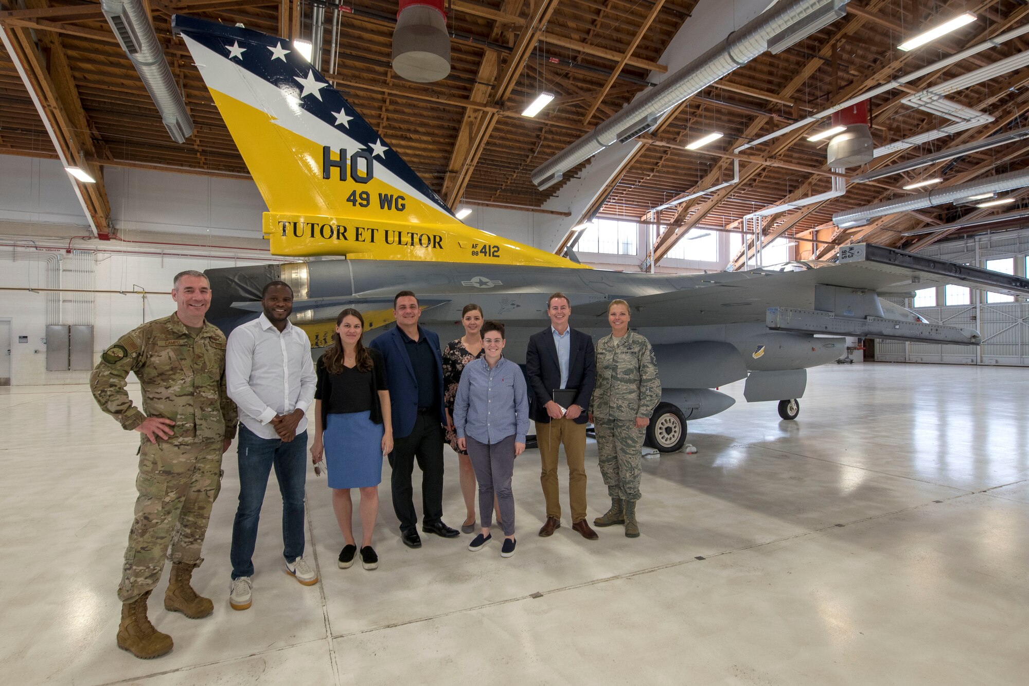 Col. Joseph Campo, 49th Wing commander and Chief Master Sgt. Sarah Esparza, 49th Wing command chief, pose with congressional staffers, Oct. 2, 2019, on Holloman Air Force Base, N.M. Staffers visited to understand the mission of the 49th Wing, which graduates combat ready aircrews and enabling support to various mission partners and tenant units. (U.S. Air Force photo by Staff Sgt. Christine Groening)
