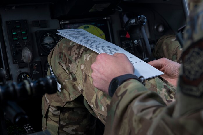 U.S. Air Force Maj. Clark Belfanti, a C-17 Globemaster III pilot assigned to the 14th Airlift Squadron, looks over his in-flight checklist during a local training flight Sept. 26, 2019, over South Carolina. Training missions allow aircrew to maintain currency, training and evaluations in all flying requirements. These training capabilities allow 14th Airlift Squadron Aircrew members to enhance rapid global mobility anytime, anywhere.