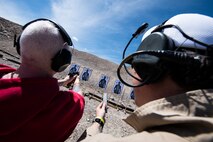 John Ferrelli, an information system security manager assigned to the 99th Communications Squadron (CS), fires a handgun at an undisclosed location in Las Vegas, April 3, 2019. Annual award winners from the 99th CS received combat tactics training as part of the Invictus Experience. (U.S. Air Force photo by Staff Sgt. Joshua Kleinholz)