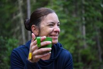 U.S. Air Force Master Sgt. Aimee Klarmann, a first sergeant assigned to the 99th Communications Squadron, wakes up with some instant coffee during a backpacking trip across the Continental Divide in Rocky Mountain National Park, Colorado, July 19, 2019. During the five-day trek, participants were challenged by variations in high-elevation mountain weather, including thunderstorms, heavy rain and hail. (U.S. Air Force photo by Staff Sgt. Joshua Kleinholz)