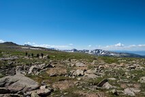 Annual award winners assigned to the 99th Communications Squadron cross a section of alpine flatland during a backpacking trip across the Continental Divide in Rocky Mountain National Park, Colorado, July 20, 2019. At such extreme elevations, harsh winds and low oxygen levels make it impossible for trees to grow. (U.S. Air Force photo by Staff Sgt. Joshua Kleinholz)