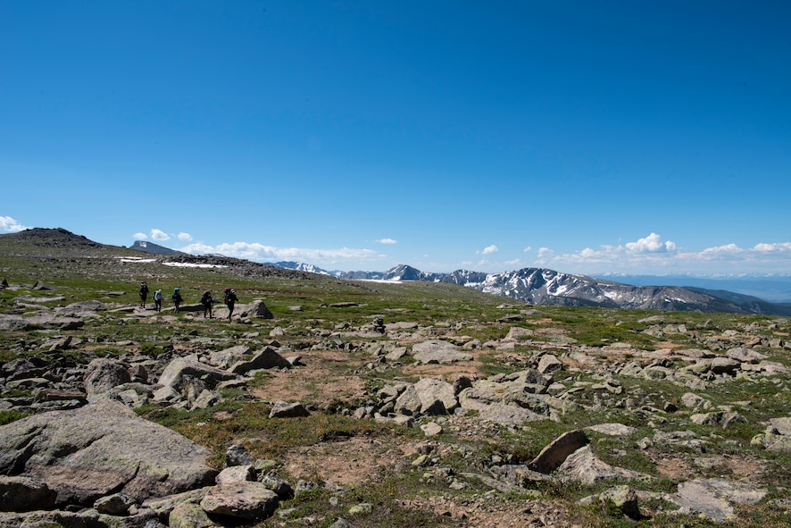 Annual award winners assigned to the 99th Communications Squadron cross a section of alpine flatland during a backpacking trip across the Continental Divide in Rocky Mountain National Park, Colorado, July 20, 2019. At such extreme elevations, harsh winds and low oxygen levels make it impossible for trees to grow. (U.S. Air Force photo by Staff Sgt. Joshua Kleinholz)