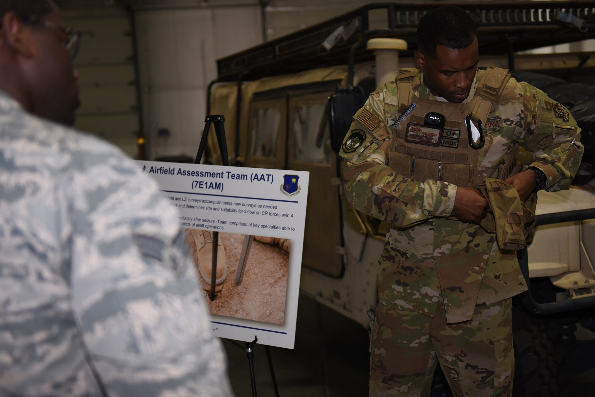U.S. Air Force Staff Sgt. Brandon Mckoy, 821st Contingency Response Squadron C-17 loadmaster, shows Airmen how to equip a plate carrier vest during the Airmen Enrichment Program Sept. 27, 2019, at Travis Air Force Base, California. The program offers Airmen the opportunity to learn about the numerous specialties the Air Force has to offer. (U.S. Air Force photo by Airman 1st Class Cameron Otte)