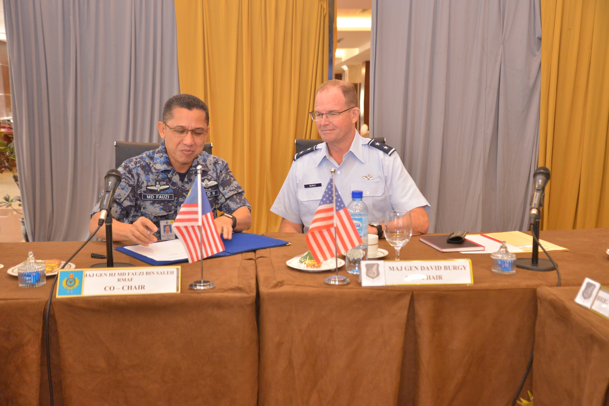 Royal Malaysian air force Maj. Gen. Dato’ Hj Md Fauzi bin Saleh, Assistant Chief of Staff, Human Resources, headquarters RMAF, and U.S. Air Force Maj. Gen. David Burgy, Air National Guard Assistant to the Commander, Pacific Air Forces, sign the meeting minutes for the second PACAF-RMAF Airman-to-Airman talks in Wisma Perwira, Kuala Lumpur, Malaysia, Sept. 4-5, 2019 . A2A talks are jointly held conferences between PACAF and regional partner air forces designed to bring together both air forces to discuss and improve on training, tactics and procedures. (Courtesy photo)