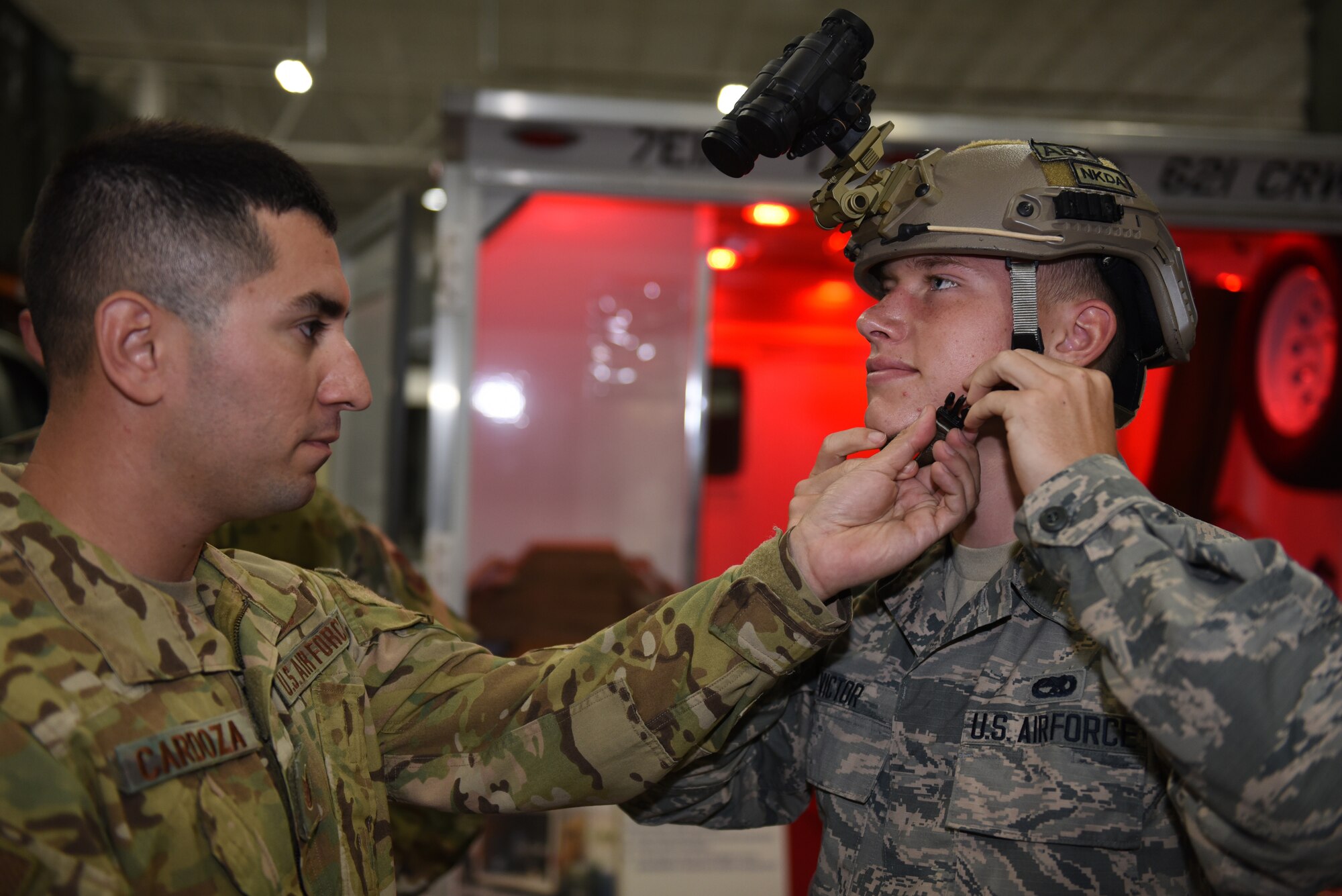 U.S. Air Force Tech. Sgt. Jose Cardoza, left, 821st Contingency Response Squadron C-17 loadmaster, helps Airman 1st Class Caden Victor, 860th Aircraft Maintenance Squadron crew chief, put on a Future Assault Shell Technology helmet with a PVS 31A night vision device attached during the Airmen Enrichment Program Sept. 27, 2019, at Travis Air Force Base, California. The program offers Airmen the opportunity to learn about the numerous specialties the Air Force has to offer. (U.S. Air Force photo by Airman 1st Class Cameron Otte)