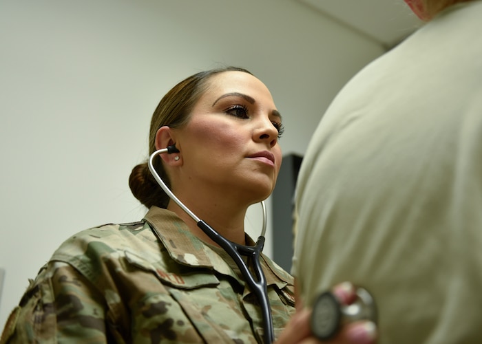 Tech. Sgt. Jerrica Wild, 21st Operational Medical Readiness Squadron independent duty medical technician, checks the breathing of a patient at the clinic on Peterson Air Force Base, Colorado, September 25, 2019. Wild is an Independent duty medical technician, the only enlisted providers in the Air Force, which allows her to diagnose and prescribe medications to patients rather than working through multiple people. (U.S. Air Force photo by Airman Alexis Christian)