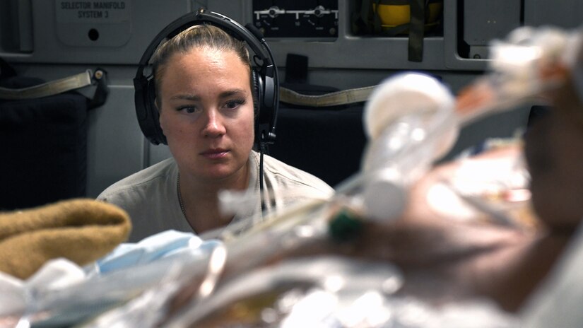Capt. Natasha Cardinal, 86th Aeromedical Evacuation Squadron critical care nurse, monitors her patient during a flight from Bagram Airfield, Afghanistan to San Antonio, Texas, Aug. 18, 2019. Critical care air transport teams are rapidly deployable teams consisting of a physician, critical care nurse and a respiratory therapist who provide a mobile intensive care unit for complex, critically wounded patients.