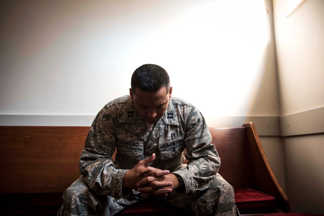 U.S. Air Force Capt. Genesis Guerrero, a 39th Air Base Wing chaplain, prays in the chapel at Incirlik Air Base, Turkey, Oct. 2, 2019. At a young age, Guerrero and his entire family fled from their home in Guam because his father’s troubled lifestyle placed them all in danger. (U.S. Air Force photo by Staff. Sgt. Joshua Magbanua)