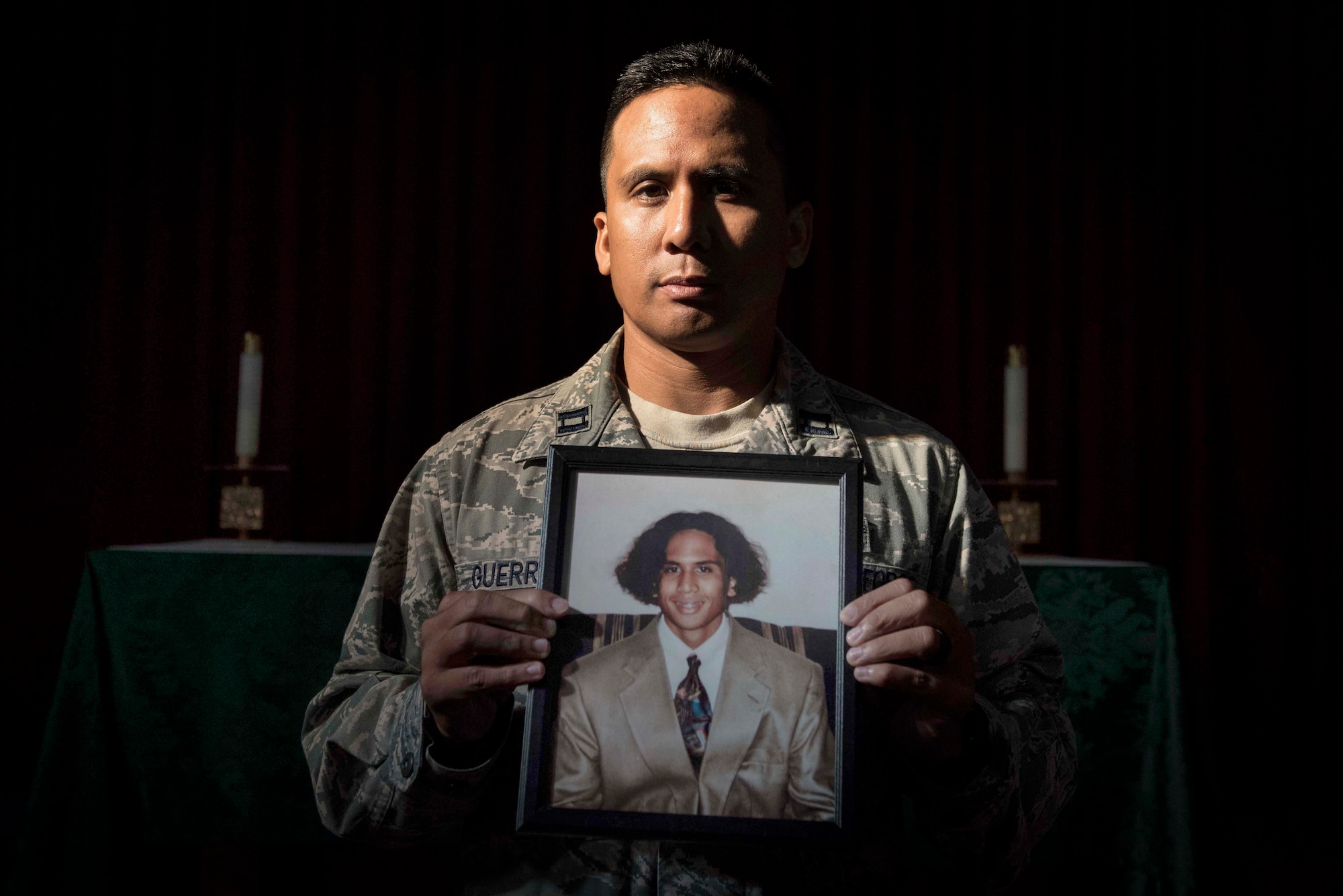 U.S. Air Force Capt. Genesis Guerrero, a 39th Air Base Wing chaplain, holds his high school portrait at Incirlik Air Base, Turkey, Oct. 2, 2019. When he was 17 years old, Guerrero used the picture to successfully dissuade his father from committing suicide. (U.S. Air Force photo by Staff. Sgt. Joshua Magbanua)