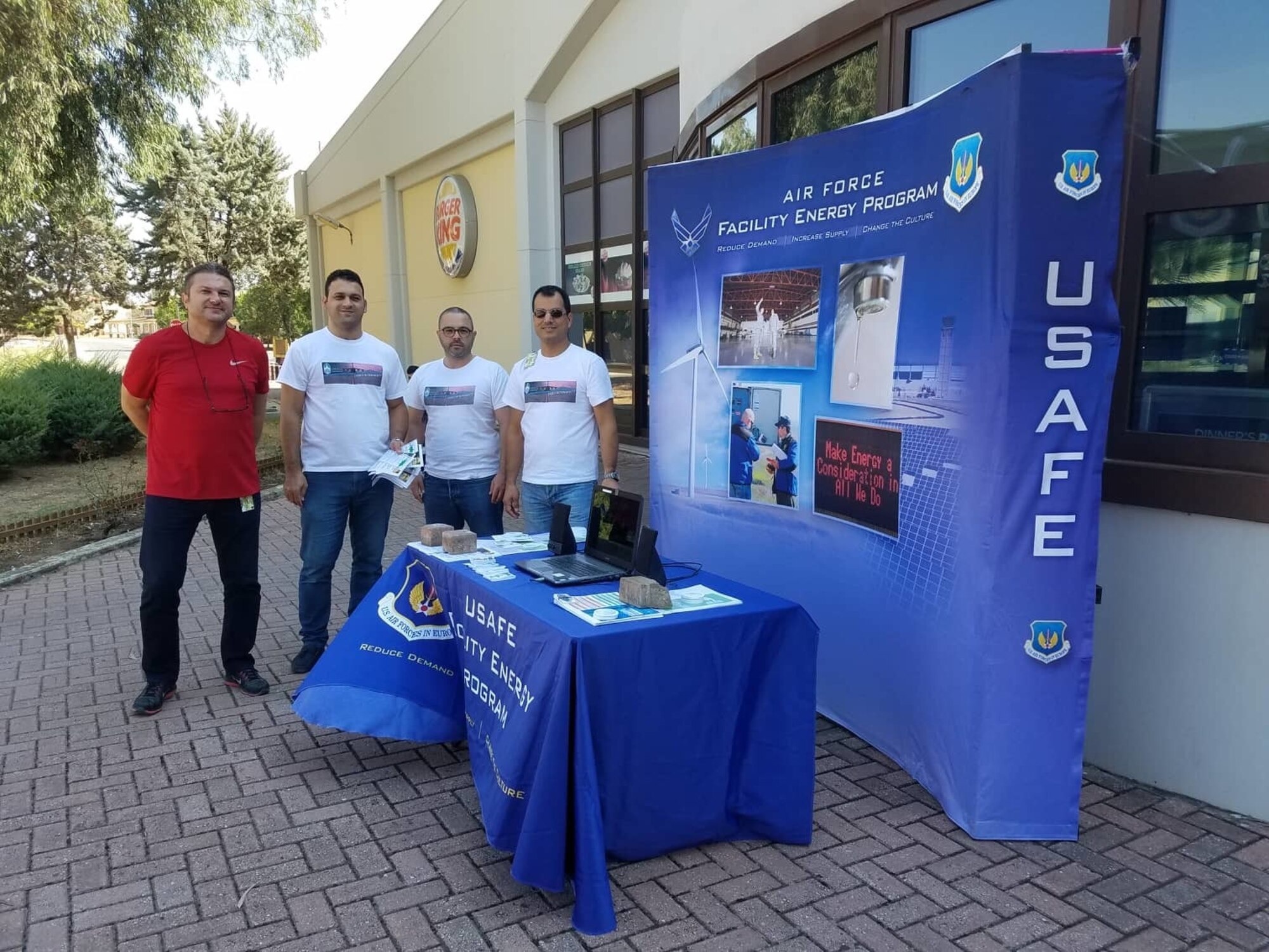Members of the 39th Civil Engineer Squadron Base Energy Management team pose at a booth outside the Base Exchange Oct. 5, 2018, at Incirlik Air Base, Turkey, to kick off Energy Action Month. October is designated as the month to educate Air Force members on the importance of reducing energy and water use. (Courtesy photo)