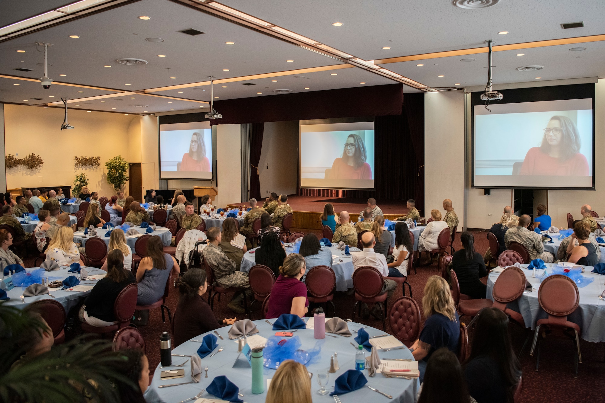 Participants in Key Spouse Kick-Off lunch and learn watch Key Spouse stories on Oct. 2, 2019, at Yokota Air Base, Japan