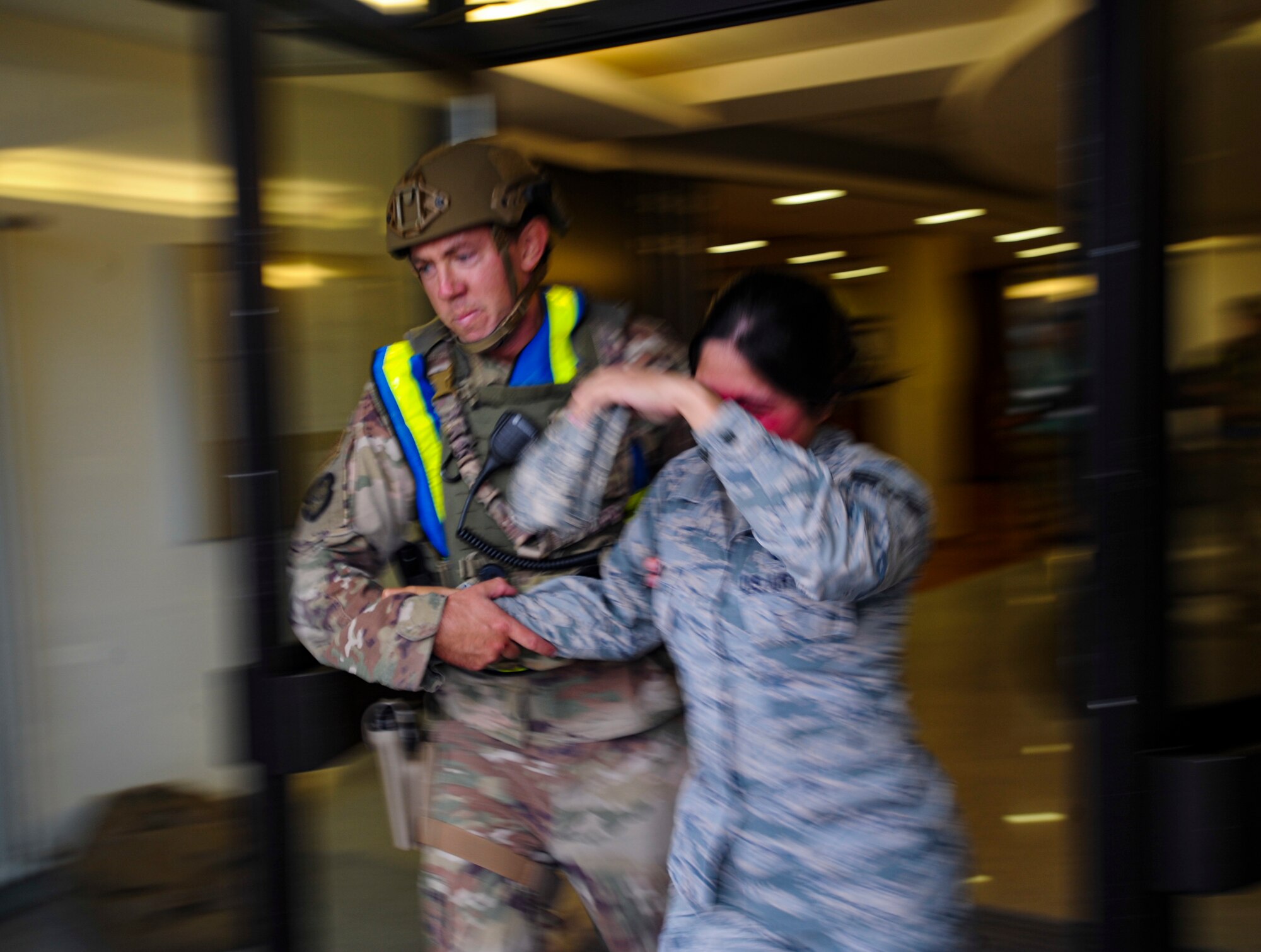 A U.S. Airmen assigned to the 86th Security Forces Squadron escorts a simulated victim out of a building at Ramstein Air Base, Germany, Sept. 25, 2019. The defender responded to a mass casualty event that was part of Operation Varsity 19-03, a weeklong exercise designed to test the capabilities of Ramstein Airmen. (U.S. Air Force photo by Tech. Sgt. Timothy Moore)