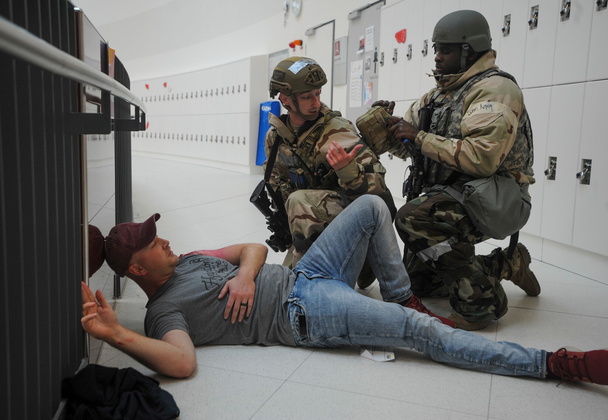 U.S. Airmen assigned to the 569th U.S. Forces Police Squadron help simulated victims of an active shooter exercise at Kaiserslautern High School at Vogelweh Military Complex, Germany, Sept. 26, 2019. The event happened as part of Operation Varsity 19-03. It also marked the first time the defenders were allowed to practice responding to an incident at the new school. (U.S. Air Force photo by Tech. Sgt. Timothy Moore)