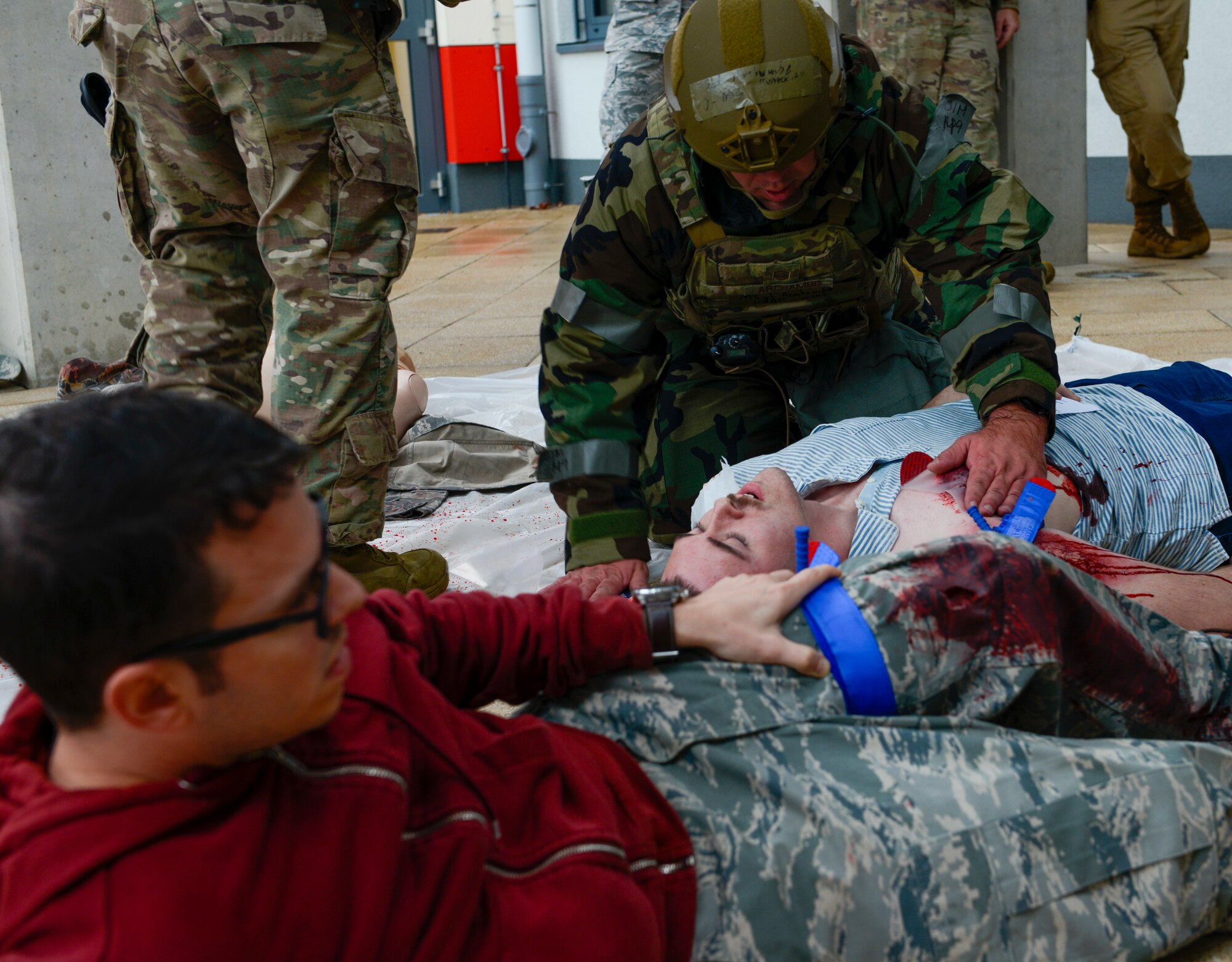 A U.S. Airman assigned to the 569th U.S. Forces Police Squadron help simulated victims of an active shooter exercise at Kaiserslautern High School at Vogelweh Military Complex, Germany, Sept. 26, 2019. The event happened as part of Operation Varsity 19-03. It also marked the first time the defenders were allowed to practice responding to an incident at the new school. (U.S. Air Force photo by Tech. Sgt. Timothy Moore)