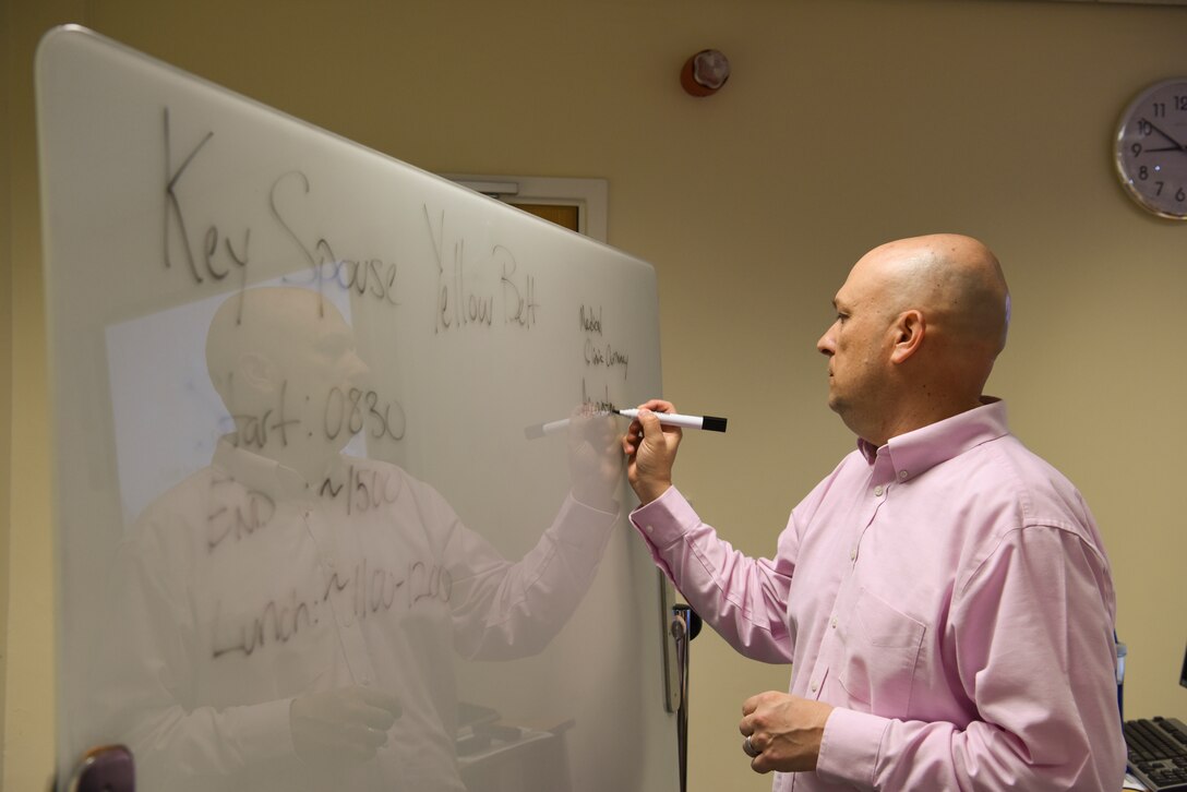 Senior Master Sgt. Stephen Holdenried, 100th Air Refueling Wing continuous process improvement manager, writes down occupations of military spouses during a CPI seminar at RAF Mildenhall, Sept. 26, 2019. The CPI seminar was to inform spouses on key principles of lean, Six Sigma method and business process reengineering. (U.S. Air Force photo by Staff Sgt. Matthew J. Wisher)