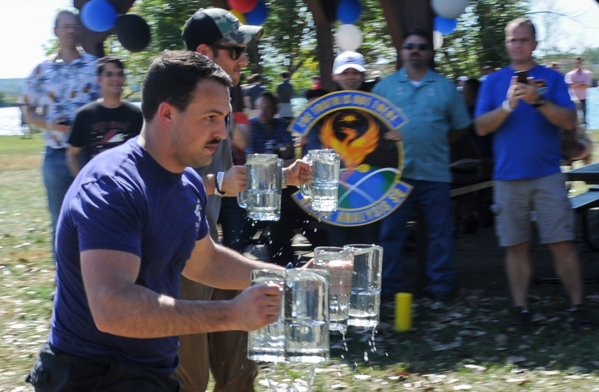 Garret Rose, National Air and Space Intelligence Center member, races to the finish line during the Stein Relay Race at NASIC’s annual Oktoberfest at Bass Lake, Wright-Patterson Air Force Base, Ohio on Sept. 27, 2019. The race was a new addition to Oktoberfest this year, replacing the log sawing competition. (U.S. Air Force photo by Senior Airman Samuel Earick/Released)