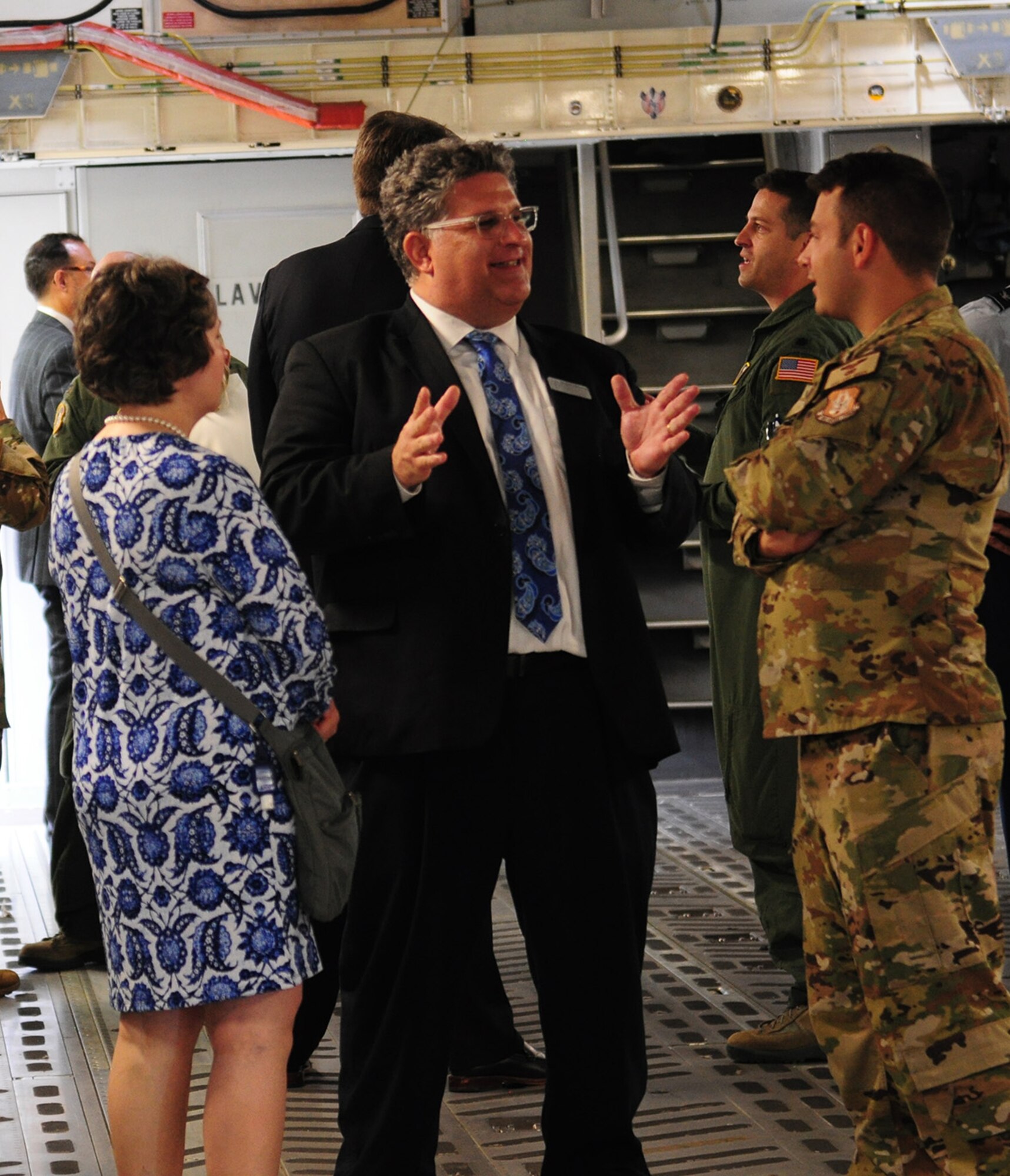 Paul Schlottman, Director of Strategic Initiatives at the University of Dayton and honorary commander for the 445th Force Support Squadron, talks to Staff Sgt. Cody Green, 89th Airlift Squadron loadmaster, during a C-17 Globemaster III tour Sept. 6, 2019. Eighteen members from the surrounding communities were officially designated as honorary commanders in an official ceremony.