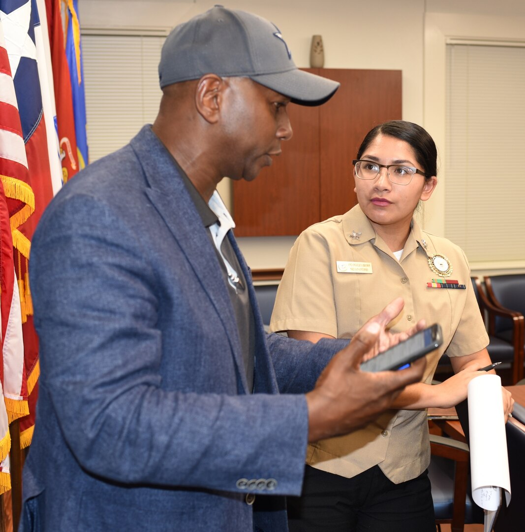 Retired Force Master Chief Brannon Knox of Veterans United Home Loans and chairman of the San Antonio Chamber of Commerce's Senior Enlisted Advisory Committee, speaks with Petty Officer 2nd Class Angelica Brown, community service coordinator assigned to Navy Recruiting District San Antonio, during a Recruiting District Assistance Council meeting at St. Philip's College's Good Samaritan Veterans Outreach and Transition Center Sept. 26. RDAC members assist Navy recruiting by joining talents available in Navy-related organizations, the civilian community, and the Naval Reserve.