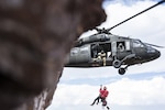 A UH-60 Black Hawk helicopter crew from the High-Altitude Army National Guard Aviation Training Site lowers a member of Mountain Rescue Aspen down to an injured hiker near the North Maroon Bells Peak near Aspen, Colorado, July 24, 2018. Colorado National Guard Soldiers at HAATS assist in about 20 rescue missions each year.