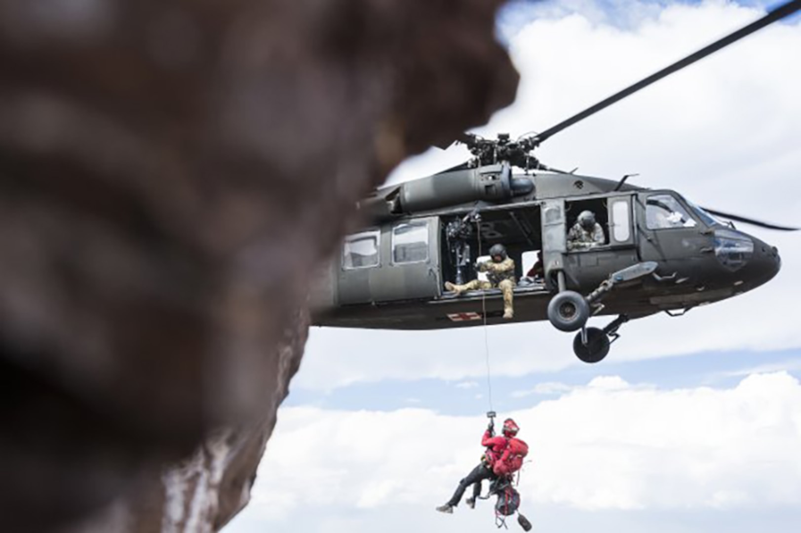A UH-60 Black Hawk helicopter crew from the High-Altitude Army National Guard Aviation Training Site lowers a member of Mountain Rescue Aspen down to an injured hiker near the North Maroon Bells Peak near Aspen, Colorado, July 24, 2018. Colorado National Guard Soldiers at HAATS assist in about 20 rescue missions each year.