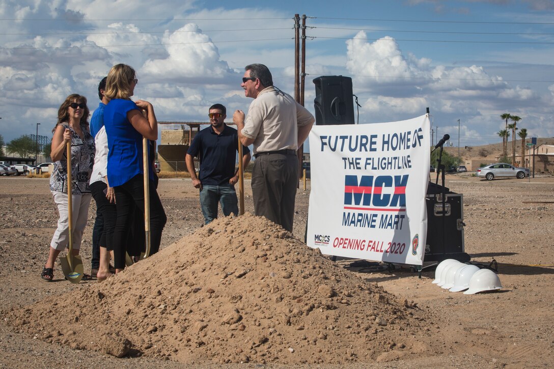 Col. David A. Suggs, the commanding officer of Marine Corps Air Station (MCAS) Yuma, John Courtis, MCAS Yuma's Auxiliary Commander and Executive Director of the Yuma County Chamber of Commerce, and other Yuma County Chamber of Commerce ambassadors shovel the first soil during the groundbreaking ceremony for the Flightline Marine Mart on MCAS Yuma, Ariz., Sept. 26, 2019. The Chamber of Commerce serves as the business voice of Yuma, advocating for both local businesses and local residents of Yuma. The new Marine Mart, set to open in 2020, will contain a barber shop, MCX shopping center, and will have a drive-thru. (U.S. Marine Corps photo by Sgt. Isaac D. Martinez)