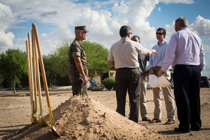 Col. David A. Suggs, the commanding officer of Marine Corps Air Station (MCAS) Yuma, John Courtis, MCAS Yuma's Auxiliary Commander and Executive Director of the Yuma County Chamber of Commerce, and other Yuma County Chamber of Commerce ambassadors shovel the first soil during the groundbreaking ceremony for the Flightline Marine Mart on MCAS Yuma, Ariz., Sept. 26, 2019. The Chamber of Commerce serves as the business voice of Yuma, advocating for both local businesses and local residents of Yuma. The new Marine Mart, set to open in 2020, will contain a barber shop, MCX shopping center, and will have a drive-thru. (U.S. Marine Corps photo by Sgt. Isaac D. Martinez)