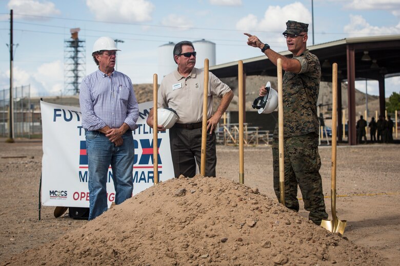 Col. David A. Suggs, the commanding officer of Marine Corps Air Station (MCAS) Yuma, John Courtis, MCAS Yuma's Auxiliary Commander and Executive Director of the Yuma County Chamber of Commerce, and other Yuma County Chamber of Commerce ambassadors shovel the first soil during the groundbreaking ceremony for the Flightline Marine Mart on MCAS Yuma, Ariz., Sept. 26, 2019. The Chamber of Commerce serves as the business voice of Yuma, advocating for both local businesses and local residents of Yuma. The new Marine Mart, set to open in 2020, will contain a barber shop, MCX shopping center, and will have a drive-thru. (U.S. Marine Corps photo by Sgt. Isaac D. Martinez)