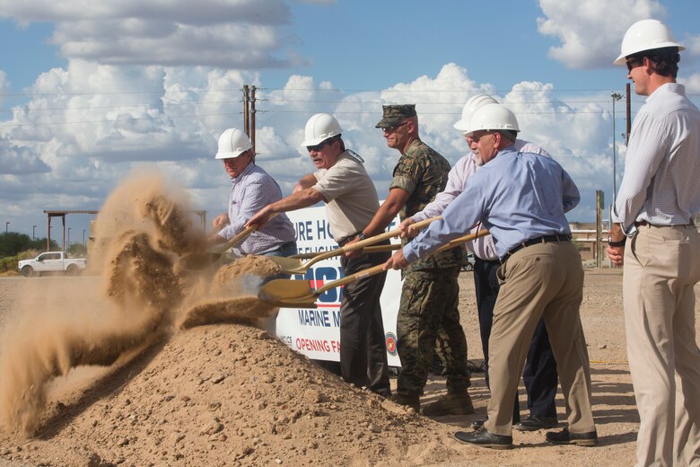 Col. David A. Suggs, the commanding officer of Marine Corps Air Station (MCAS) Yuma, John Courtis, MCAS Yuma's Auxiliary Commander and Executive Director of the Yuma County Chamber of Commerce, and other Yuma County Chamber of Commerce ambassadors shovel the first soil during the groundbreaking ceremony for the Flightline Marine Mart on MCAS Yuma, Ariz., Sept. 26, 2019. The Chamber of Commerce serves as the business voice of Yuma, advocating for both local businesses and local residents of Yuma. The new Marine Mart, set to open in 2020, will contain a barber shop, MCX shopping center, and will have a drive-thru. (U.S. Marine Corps photo by Sgt. Isaac D. Martinez)