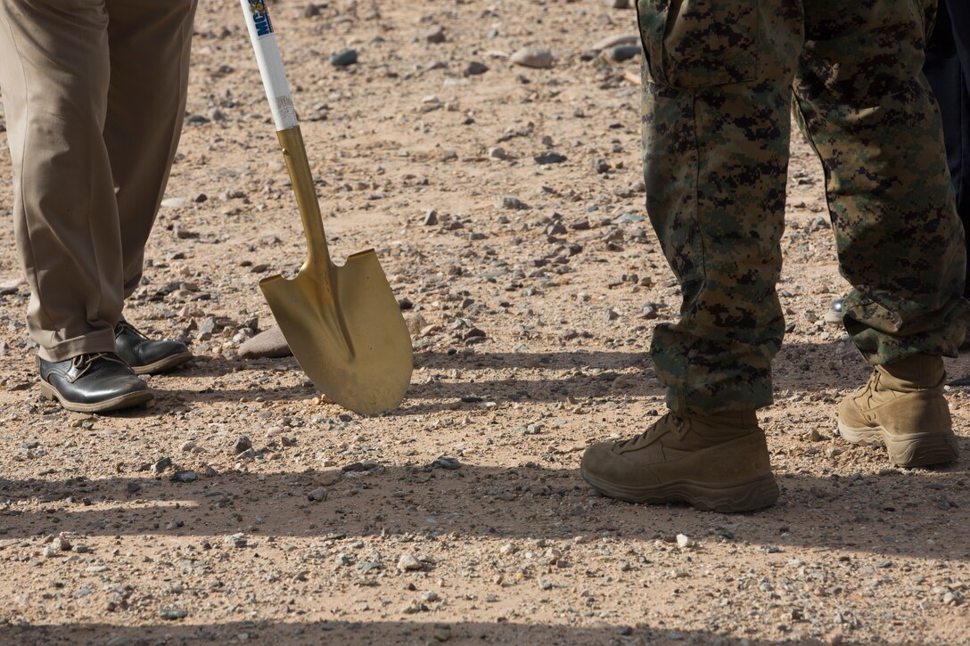 Col. David A. Suggs, the commanding officer of Marine Corps Air Station (MCAS) Yuma, John Courtis, MCAS Yuma's Auxiliary Commander and Executive Director of the Yuma County Chamber of Commerce, and other Yuma County Chamber of Commerce ambassadors shovel the first soil during the groundbreaking ceremony for the Flightline Marine Mart on MCAS Yuma, Ariz., Sept. 26, 2019. The Chamber of Commerce serves as the business voice of Yuma, advocating for both local businesses and local residents of Yuma. The new Marine Mart, set to open in 2020, will contain a barber shop, MCX shopping center, and will have a drive-thru. (U.S. Marine Corps photo by Sgt. Isaac D. Martinez)