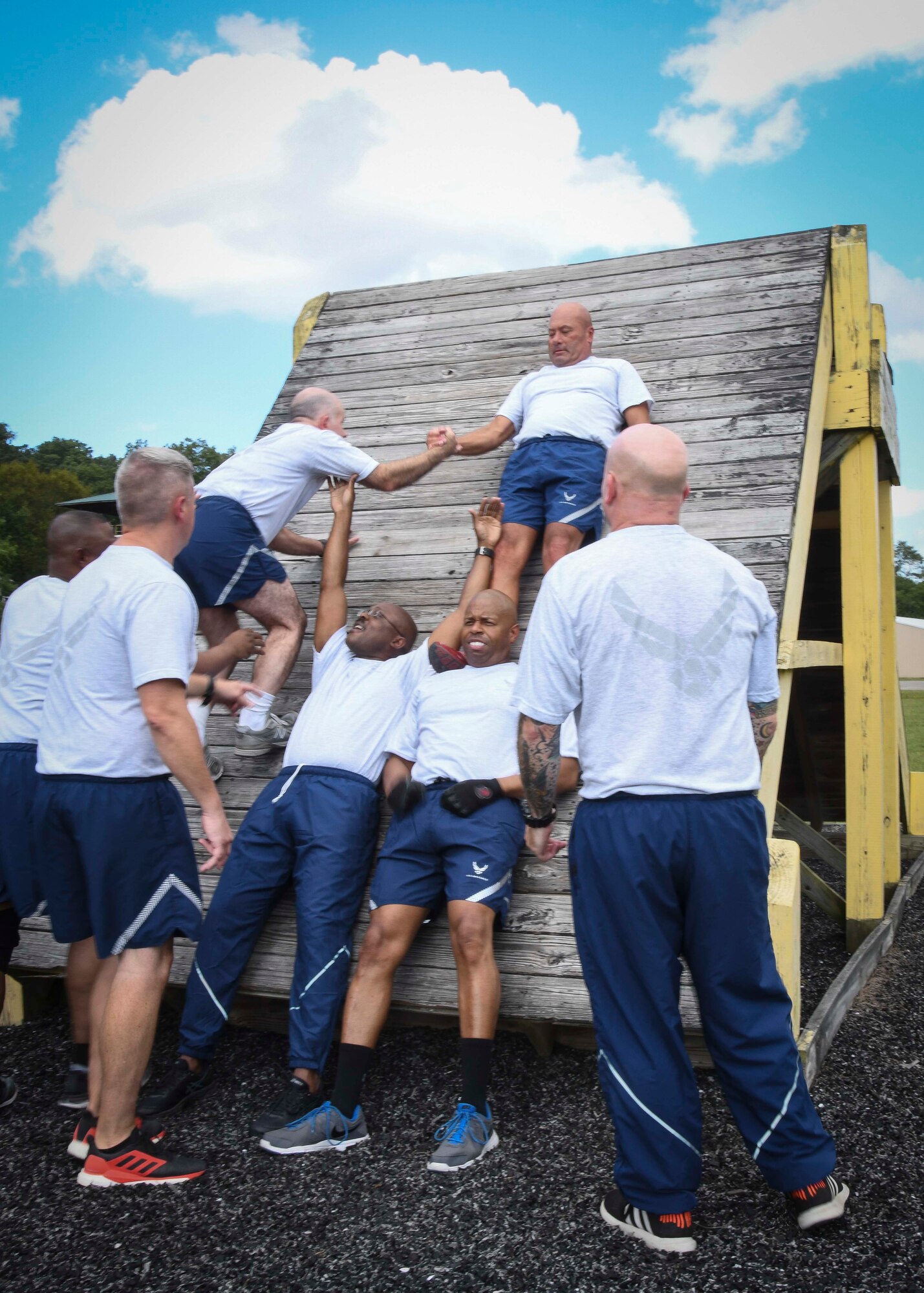 U.S. Air force chief caster sergeants, assigned to the Air National Guard Readiness Center, work together to complete a Leadership Reaction Course obstacle at Camp Dawson, West Virginia, Sept. 14, 2019. The LRC was an event hosted during the ANGRC’s Back to the Basics teambuilding off-site and challenged the chiefs’ strength, teamwork and problem-solving skills. (U.S. Air National Guard photo by Staff Sgt. Morgan R. Lipinski)