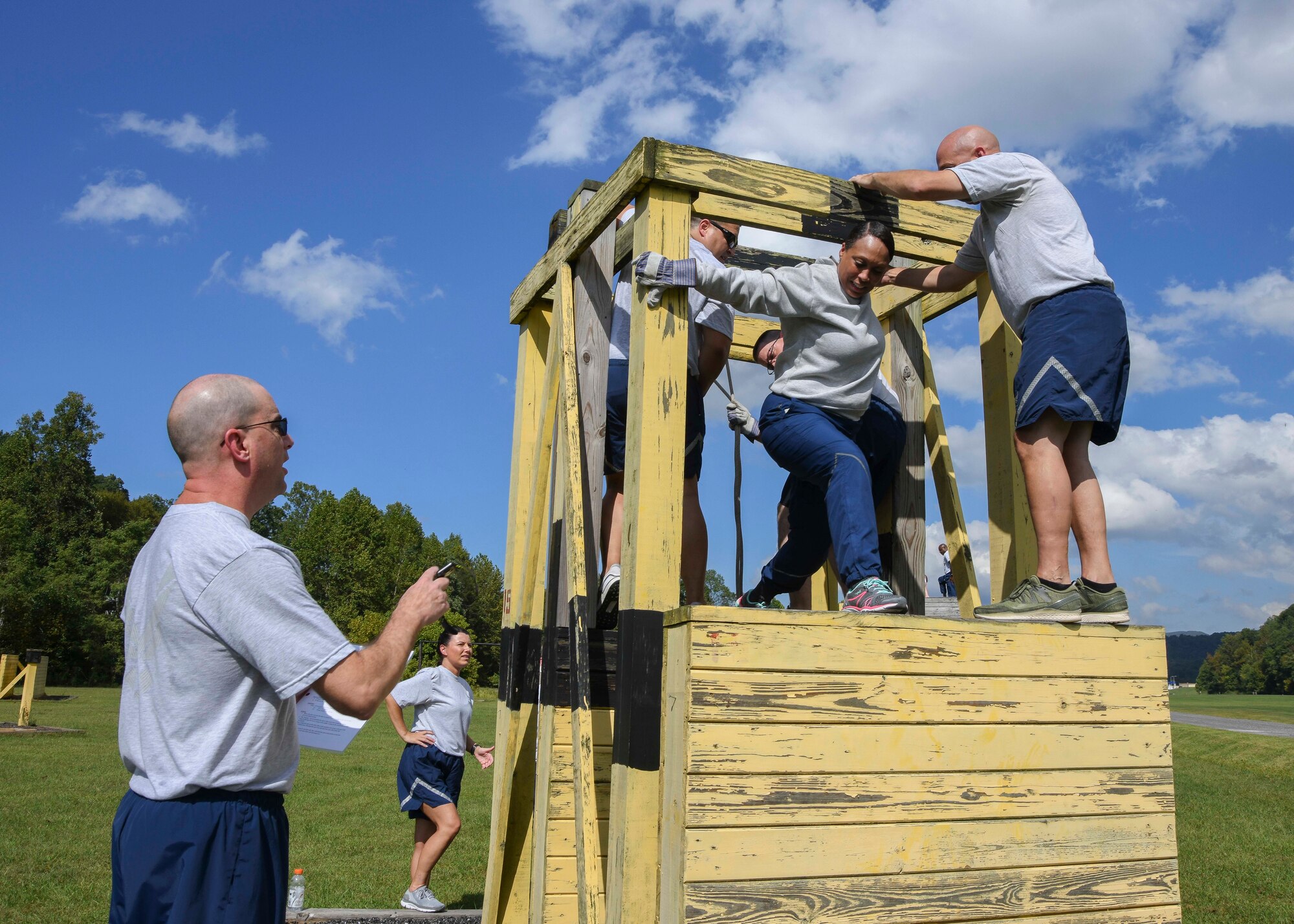 U.S. Air force chief caster sergeants, assigned to the Air National Guard Readiness Center, work together to complete a Leadership Reaction Course obstacle at Camp Dawson, West Virginia, Sept. 14, 2019. The LRC was held during the ANGRC’s Back to the Basics teambuilding off-site event that challenged the chiefs’ strength, teamwork, and problem-solving skills. (U.S. Air National Guard photo by Staff Sgt. Morgan R. Lipinski)