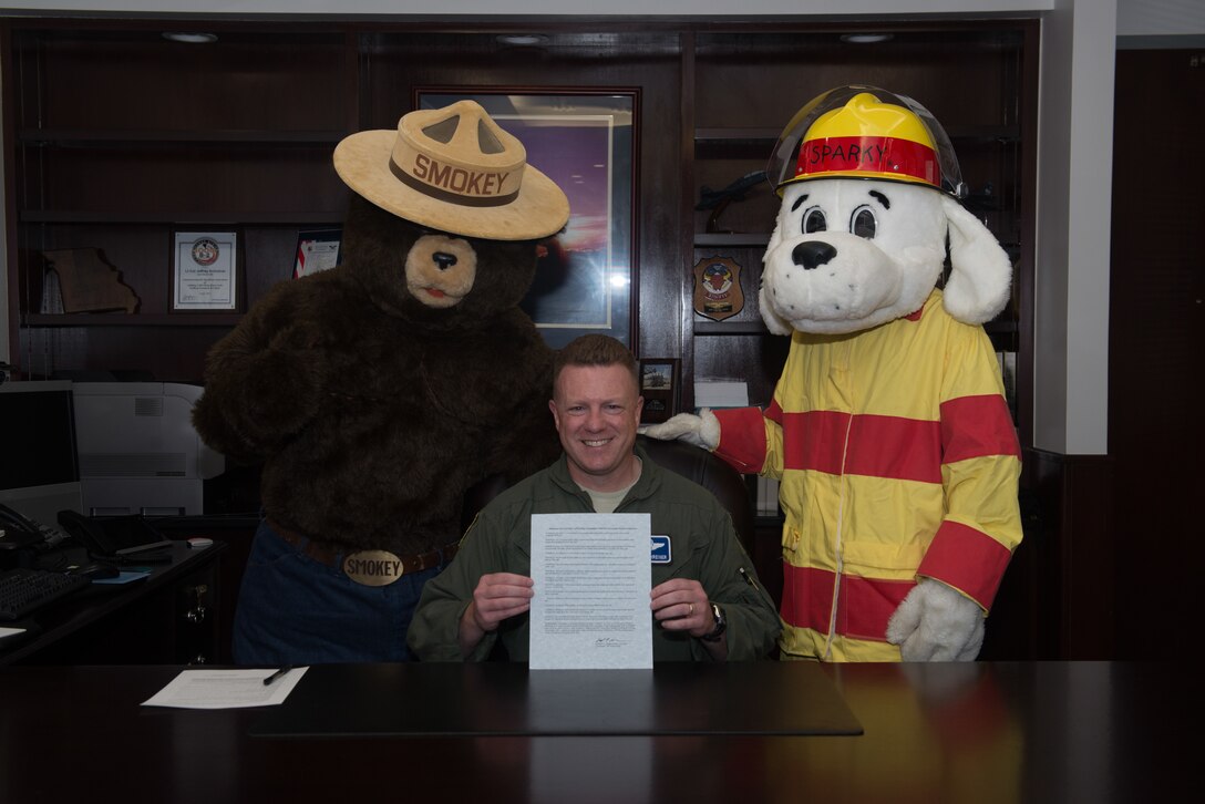 Col. Jeffrey Schreiner, commander of the 509th Bomb Wing, poses for a photo with fire prevention mascots on September 13, 2019, at Whiteman Air Force Base, Missouri. Schreiner signed a proclamation announcing his and the base's commitment to fire safety. (U.S. Air Force photo by Airman 1st Class Parker J. McCauley)