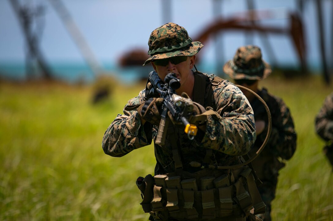 U.S. Marine Lance Cpl. Conner Travis, a rifleman with 2nd Battalion, 2nd Marine Regiment, currently assigned to 3rd Marine Division, demonstrates how they conduct an ambush to the members of the Malaysian Armed Forces during Tiger Strike 2019. Tiger Strike 19 focuses on strengthening joint military interoperability and on increasing readiness by practicing for humanitarian assistance, disaster relief, amphibious and jungle warfare operations, all while fostering cultural exchanges between the MAF and the U.S. Navy, Marine Corps team.