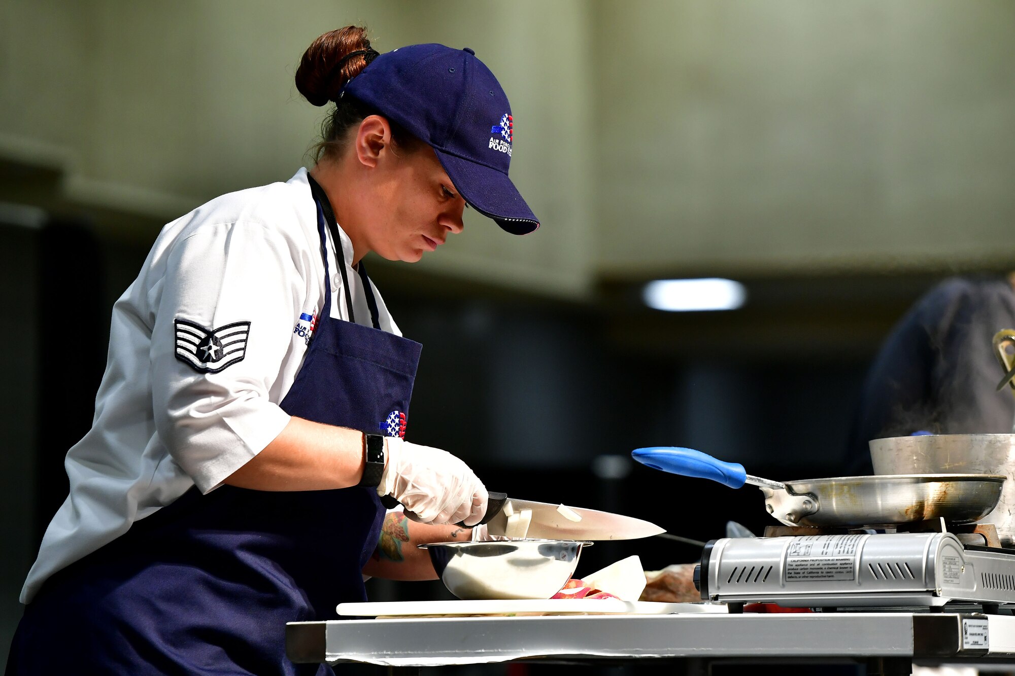 An Airman chops onions during the Iron Chef Championship competition