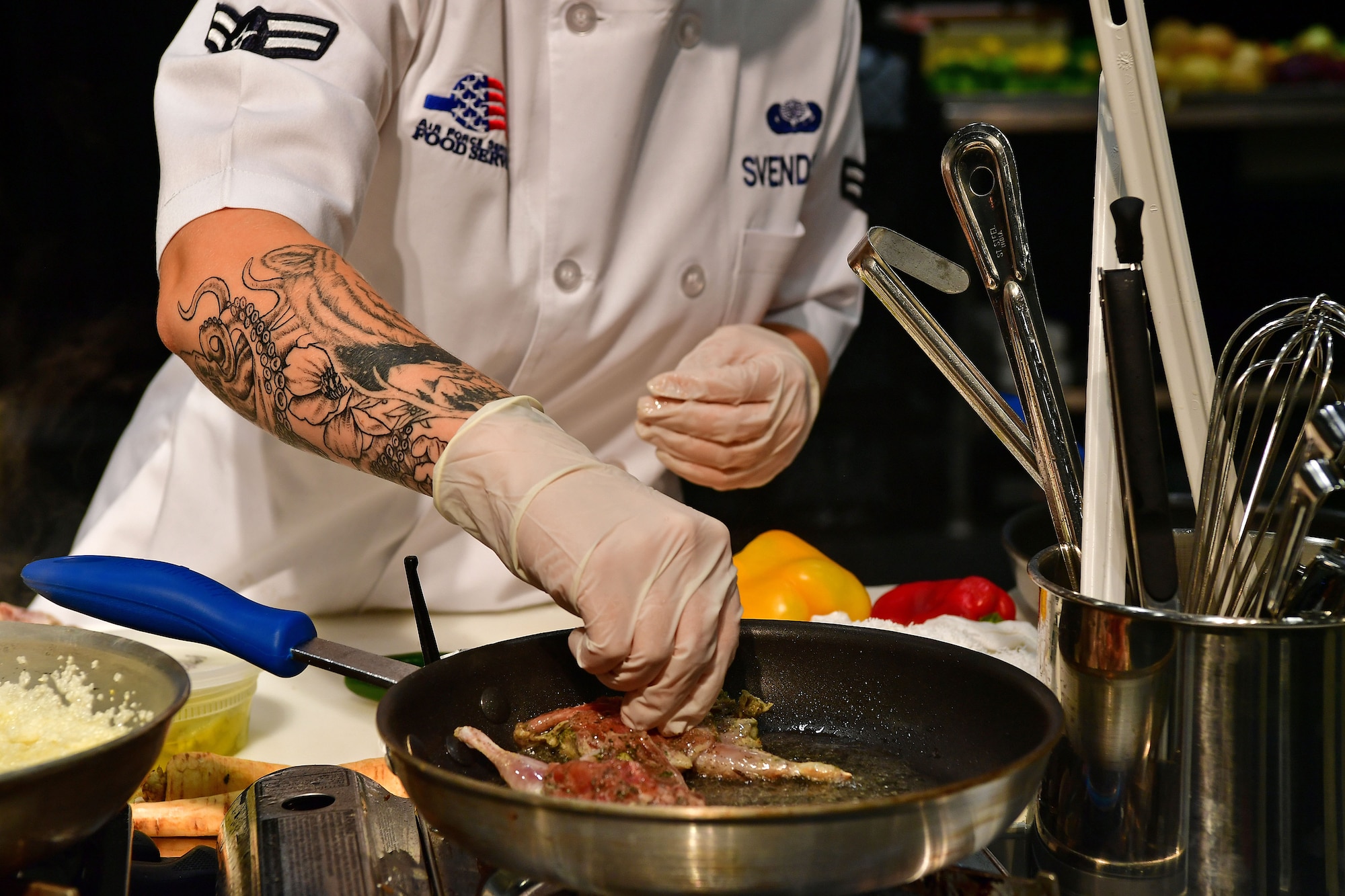 An Airman cooks quail during the Iron Chef Championship competition