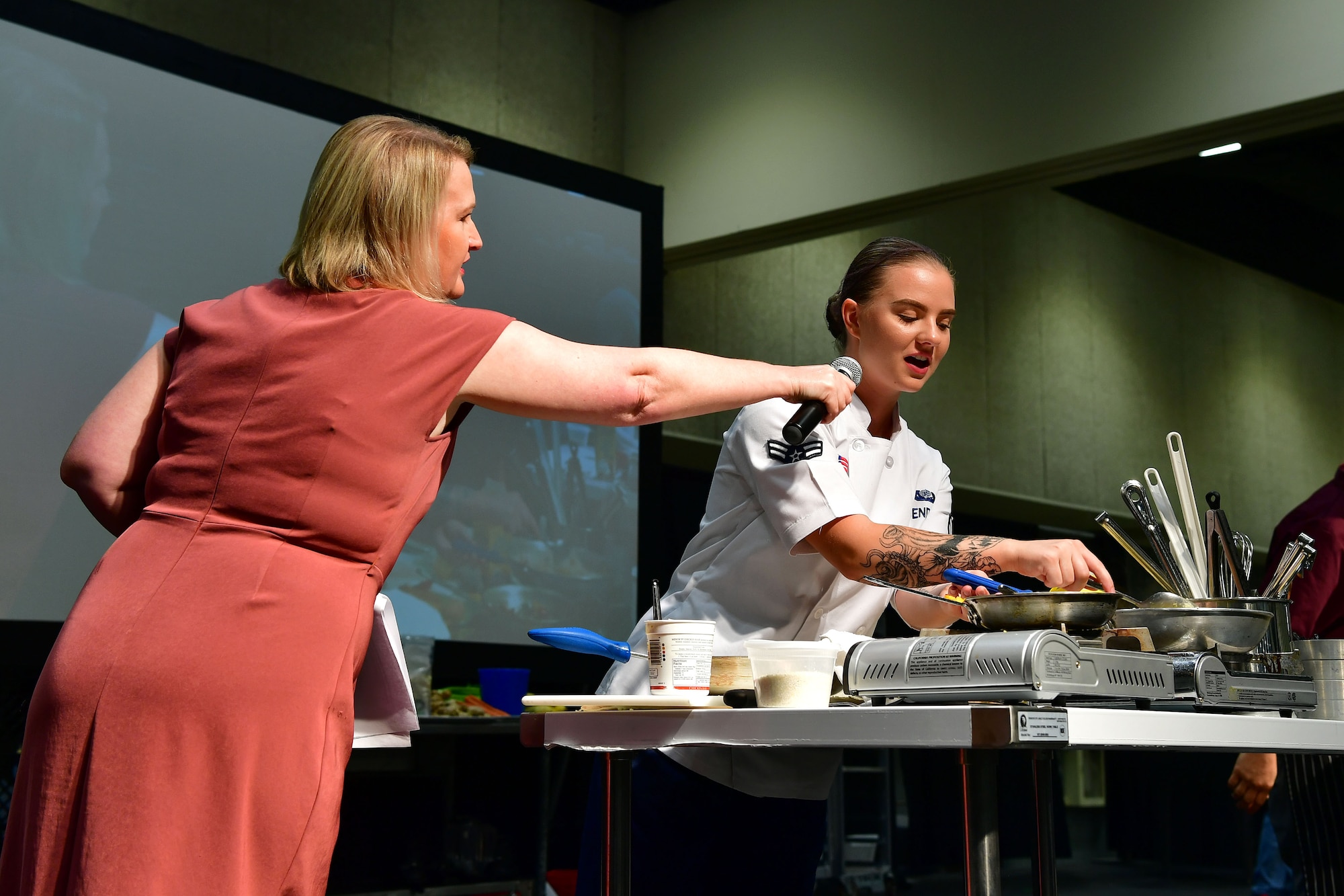 An Airman answers questions from the announcer during the Iron Chef Championship competition.