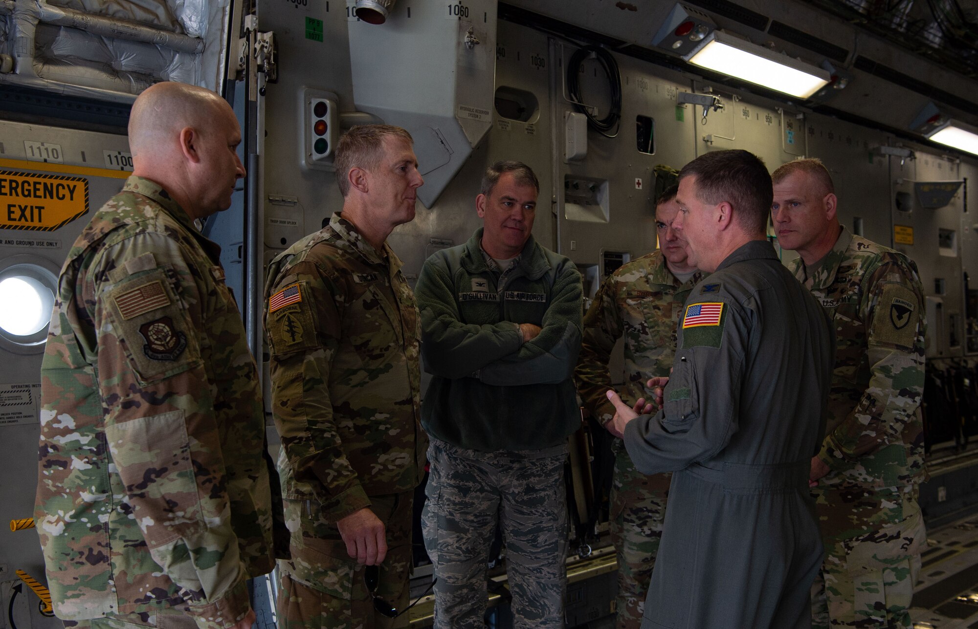 U.S. Air Force Col. Scovill Currin (front right), 62nd Airlift Wing commander, talks to Joint Base Lewis-McChord (JBLM) and Team McChord leaders about interoperability between the Air Force and Army inside a C-17 Globemaster III at Moses Lake Municipal Airport, Wash., Oct. 1, 2019. Soldiers from the 51st Expeditionary Signal Battalion, 35th Signal Brigade, tested their long-range communication equipment from Moses Lake to JBLM for a mobility movement exercise. (U.S. Air Force photo by Senior Airman Tryphena Mayhugh)