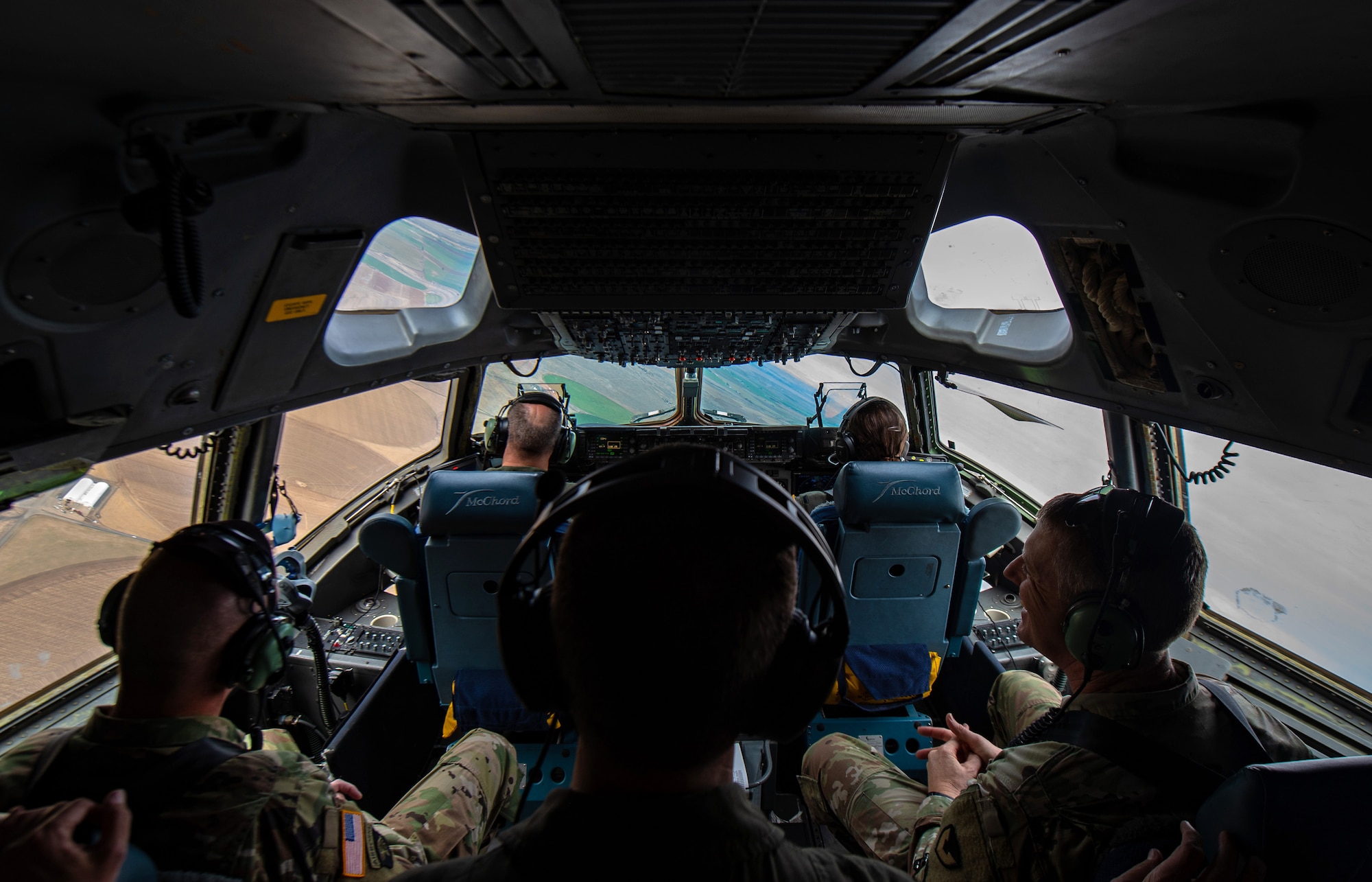 From back right, U.S. Army Col. Skye Duncan, Joint Base Lewis-McChord (JBLM) commander; U.S. Air Force Col. Scovill Currin, 62nd Airlift Wing commander; and U.S. Army Command Sergeant Major Timothy Marble, JBLM command sergeant major, sit in the flight deck of a C-17 Globemaster III near Moses Lake Municipal Airport, Wash., Oct. 1, 2019. The purpose of the flight was to provide training opportunities for Airmen and Soldiers in a mobility movement exercise. (U.S. Air Force photo by Senior Airman Tryphena Mayhugh)