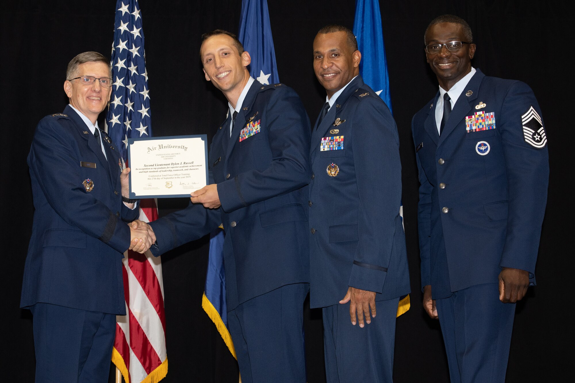 Gen. Tim Ray, Air Force Global Strike Command commander, presents the top graduate award for the 24th Training Squadron to 2nd Lt. Dylan Russel from Air University’s Officer Training School “Godzilla” class 19-07 during an awards ceremony at the Alabama State University Acadome, Montgomery, Ala., Sept. 26, 2019. Class 19-07, dubbed internally as “Godzilla,” started with more than 800 officer trainees, effectively double the average class size.