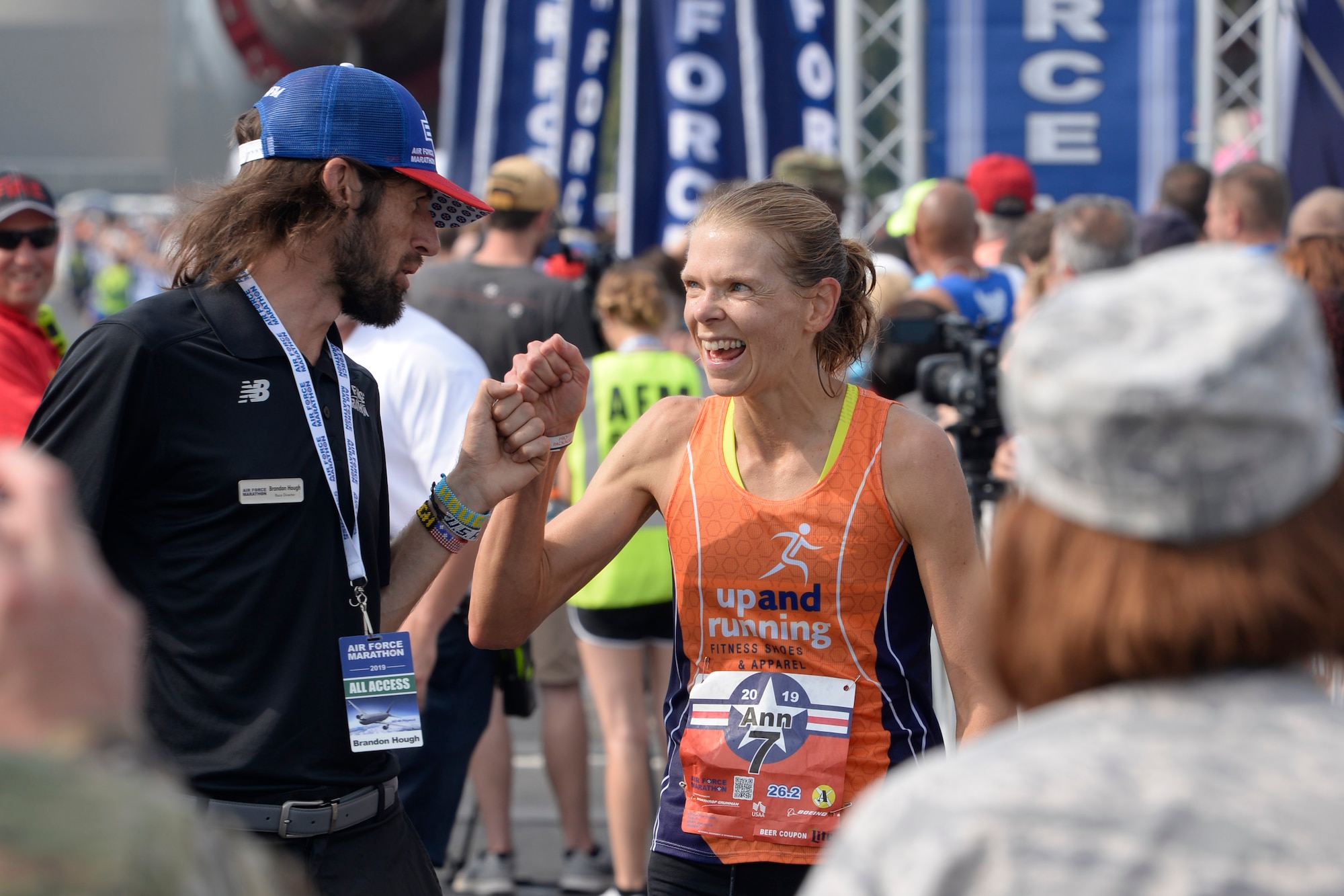 Brandon Hough, Air Force Marathon director, congratulates the full marathon female winner Ann Alyanak from Bellbrook, Ohio, at the Air Force Marathon at Wright-Patterson Air Force Base, Ohio, on Sept. 21. (U.S. Air Force photo/Ty Greenlees)