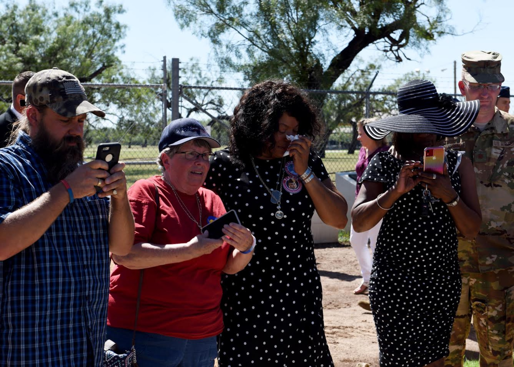 Family members of fallen Airmen from TORQE 62 take photos of a memorial in Abilene, Texas, Oct. 2, 2019.