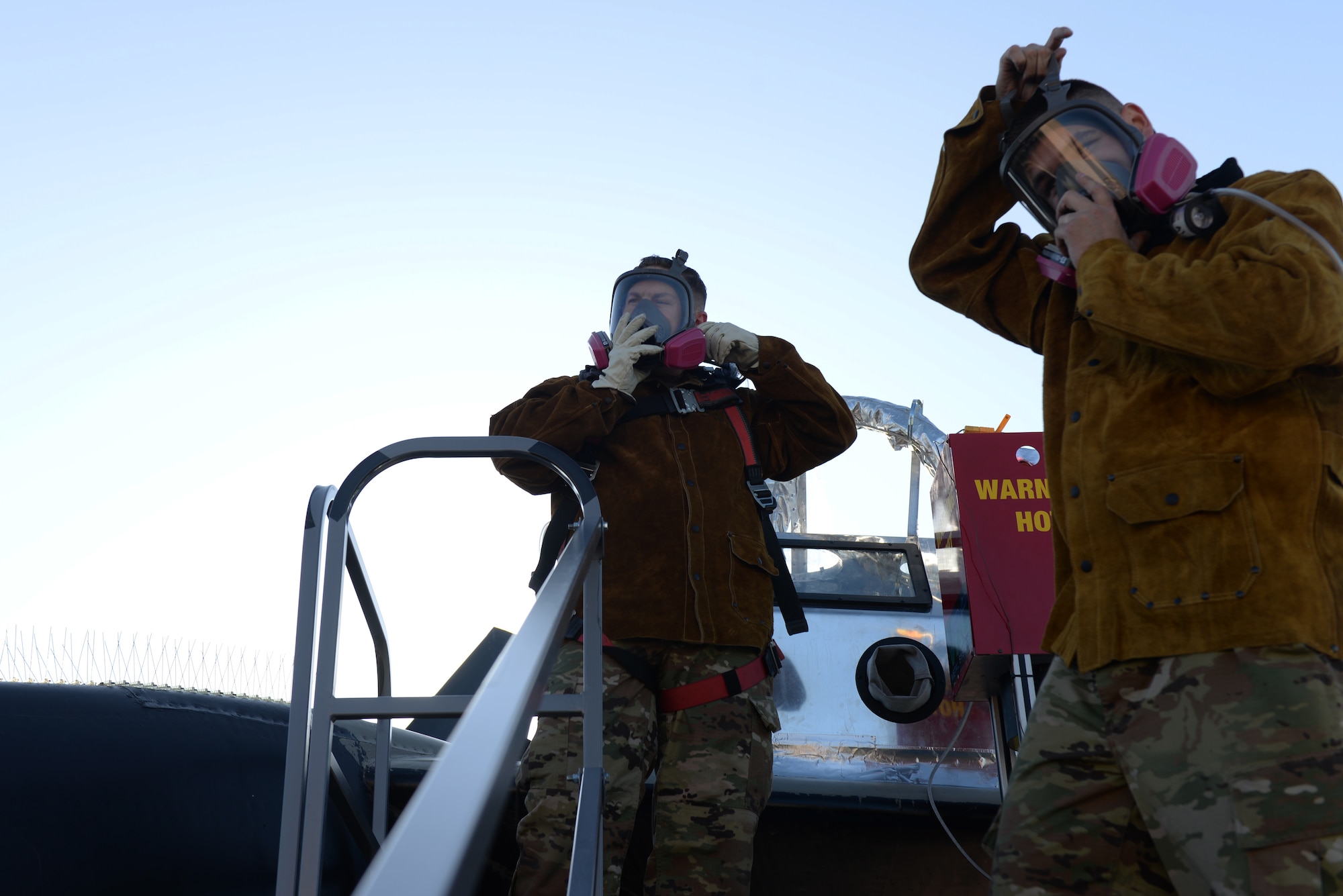 28th Maintenance Squadron Additive Manufacturing Rapid Repair Facility Airmen put on gas masks at the South Dakota Air and Space Museum in Box Elder, S.D., Sept. 18, 2019. The Airmen must wear protective gear so the spherical aluminum particles that shoot out at supersonic speeds do not get into their lungs, as well as the other gases used. (U.S. Air Force photo by Airman Quentin K. Marx)