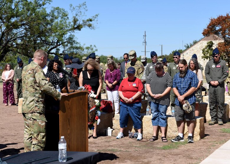 Maj. John Rollyson, 7th Bomb Wing chaplain, left, prays for the Airmen lost during TORQE 62 in Abilene, Texas, Oct. 2, 2019.