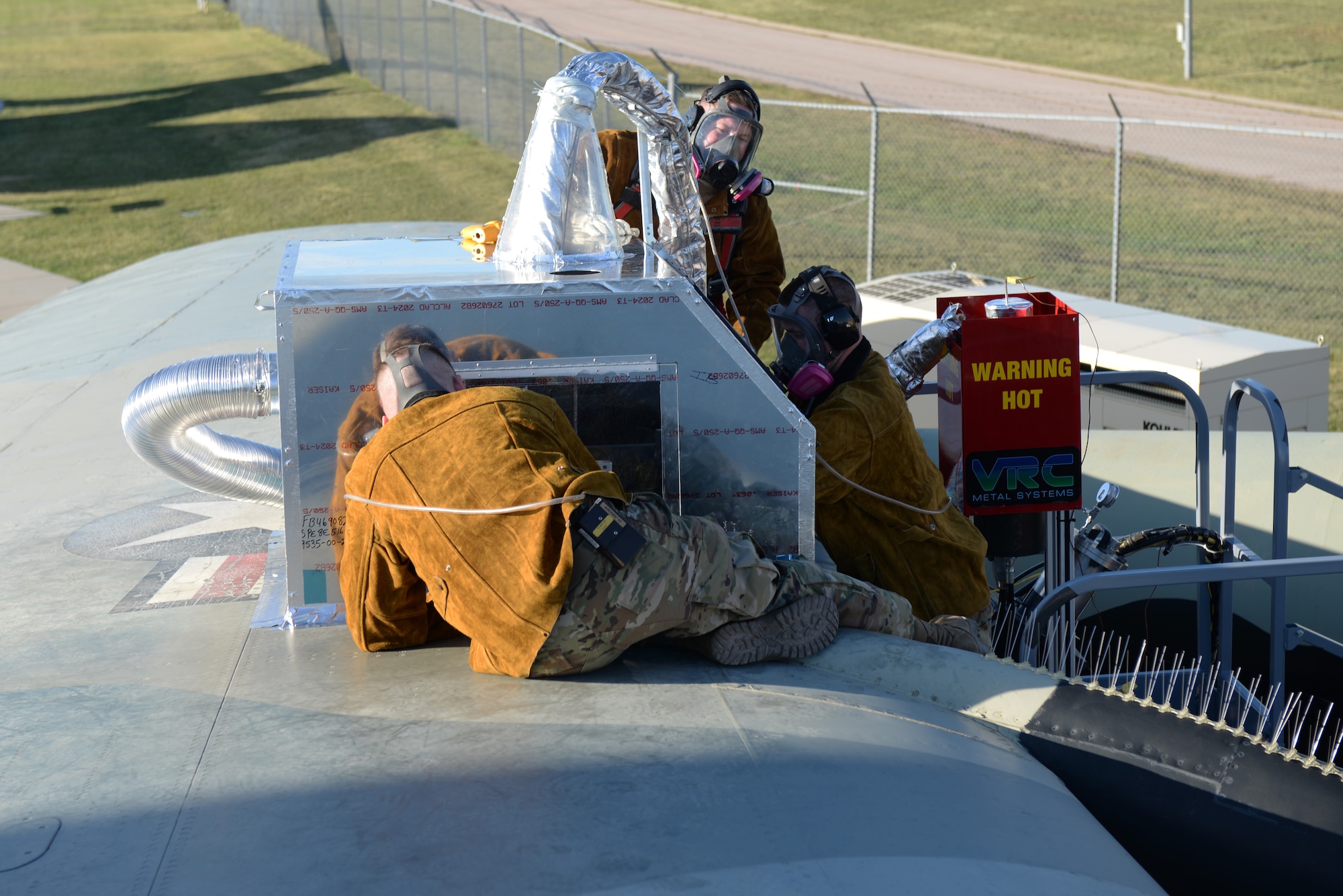28th Maintenance Squadron Additive Manufacturing Rapid Repair Facility Airmen perform a Cold Spray repair on the B-52 Stratofortress static display at the South Dakota Air and Space Museum in Box Elder, S.D., Sept. 18, 2019. The GEN III High-Pressure Cold Spray unit uses helium gas to accelerate spherical aluminum particles to bond with the surface needing repaired. (U.S. Air Force photo by Airman Quentin K. Marx)