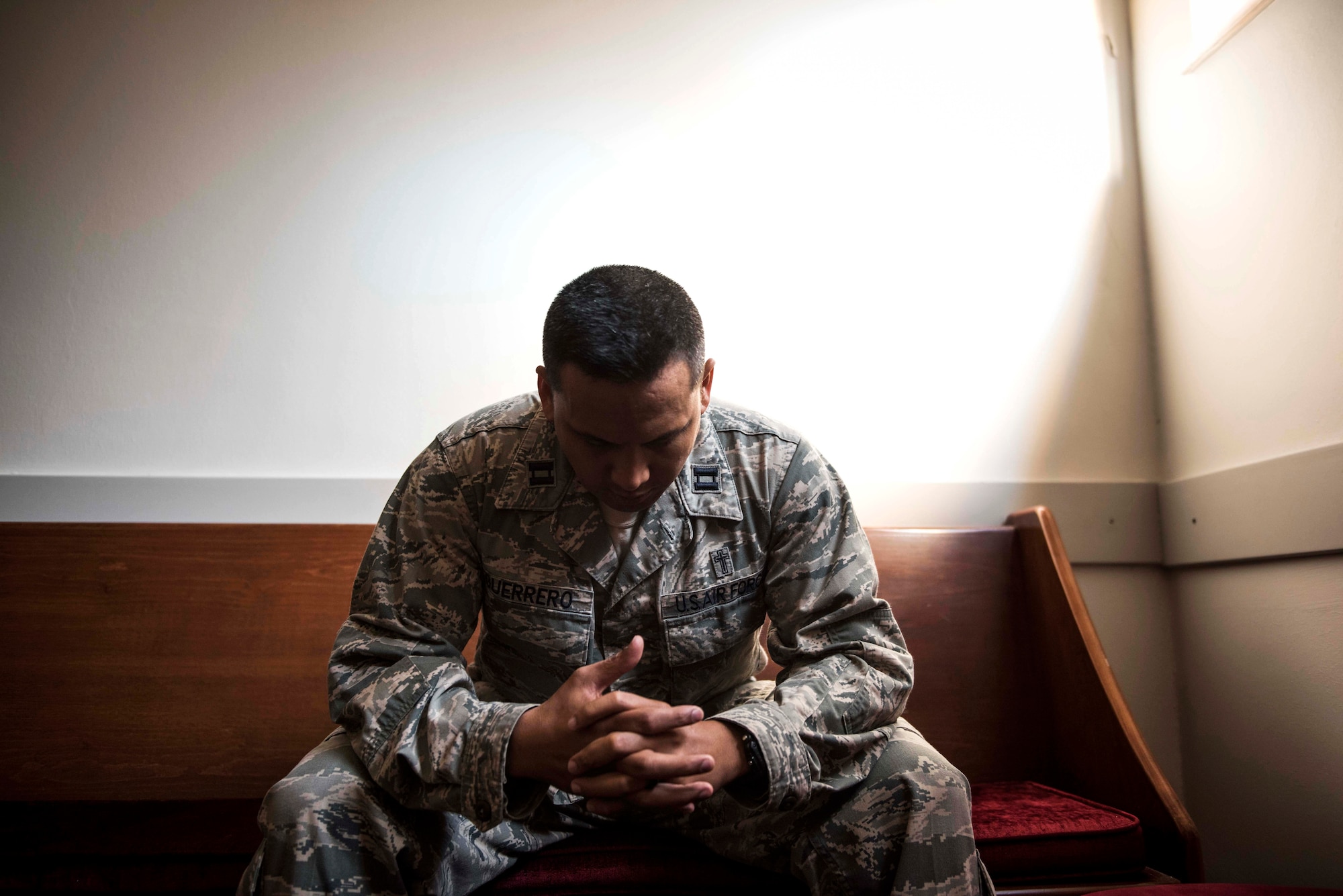 U.S. Air Force Capt. Genesis Guerrero, a 39th Air Base Wing chaplain, prays in the chapel at Incirlik Air Base, Turkey, Oct. 2, 2019. At a young age, Guerrero and his entire family fled from their home in Guam because his father’s troubled lifestyle placed them all in danger. (U.S. Air Force photo by Staff. Sgt. Joshua Magbanua)