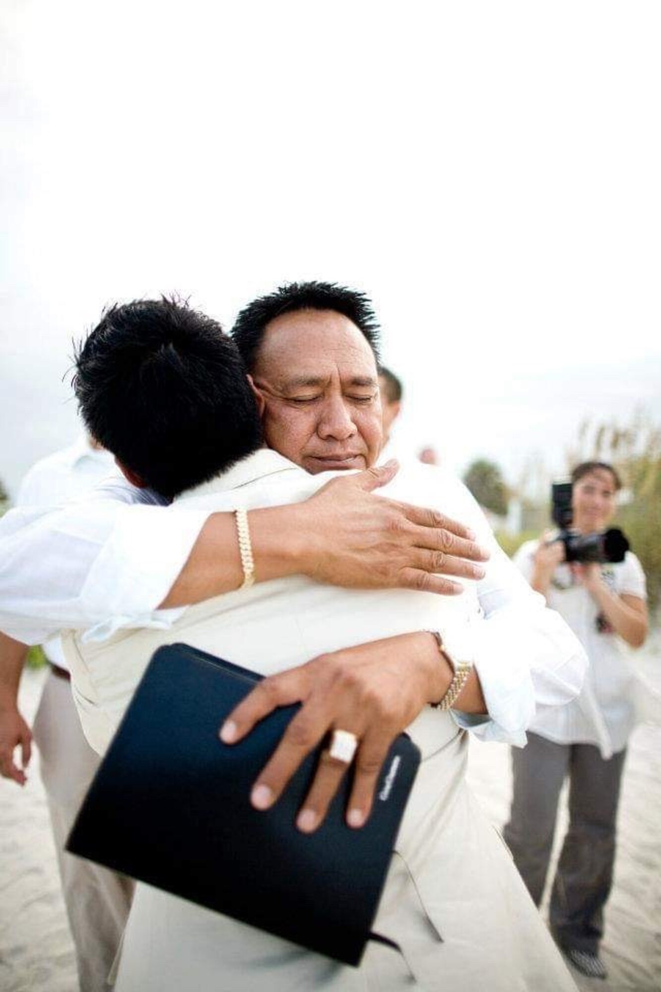 U.S. Air Force Capt. Genesis Guerrero, now a chaplain for the 39th Air Base Wing, (front) receives a hug from his father, Gene (face shown), on his wedding day, Aug. 1, 2009, at St. Augustine, Fla. As a chaplain, Guerrero draws inspiration from his experience in forgiving his father’s troubled lifestyle, and seeks to help Airmen find peace through forgiveness and reconciliation, (Courtesy photo)
